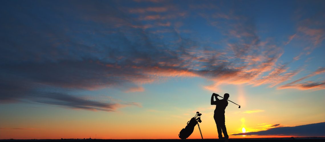 man golf player hit ball to air during sunset silhouetted